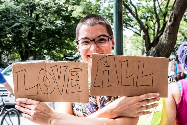 "Mazzoni Center - Person holding 'Love All' sign" by the Philadelphia Bar Foundation's nonprofit partner, Mazzoni Center
