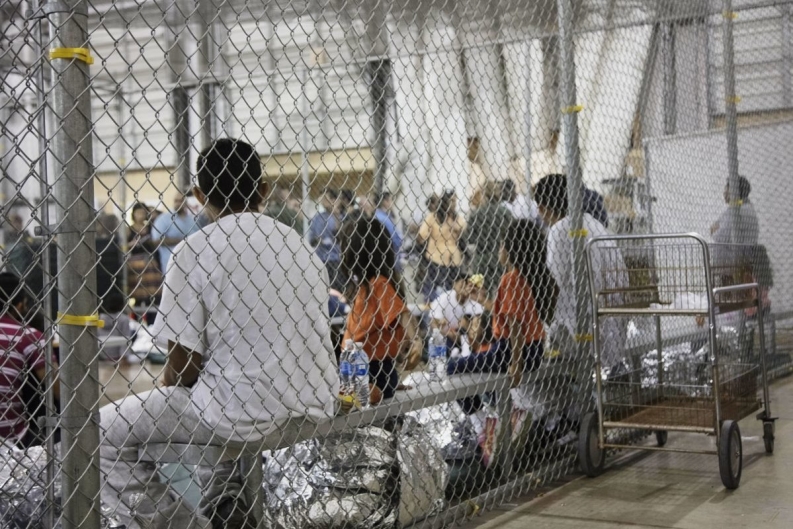 People siting in a cage.