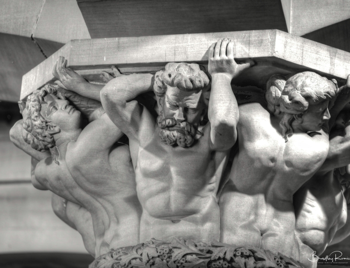 Statue holding pillar